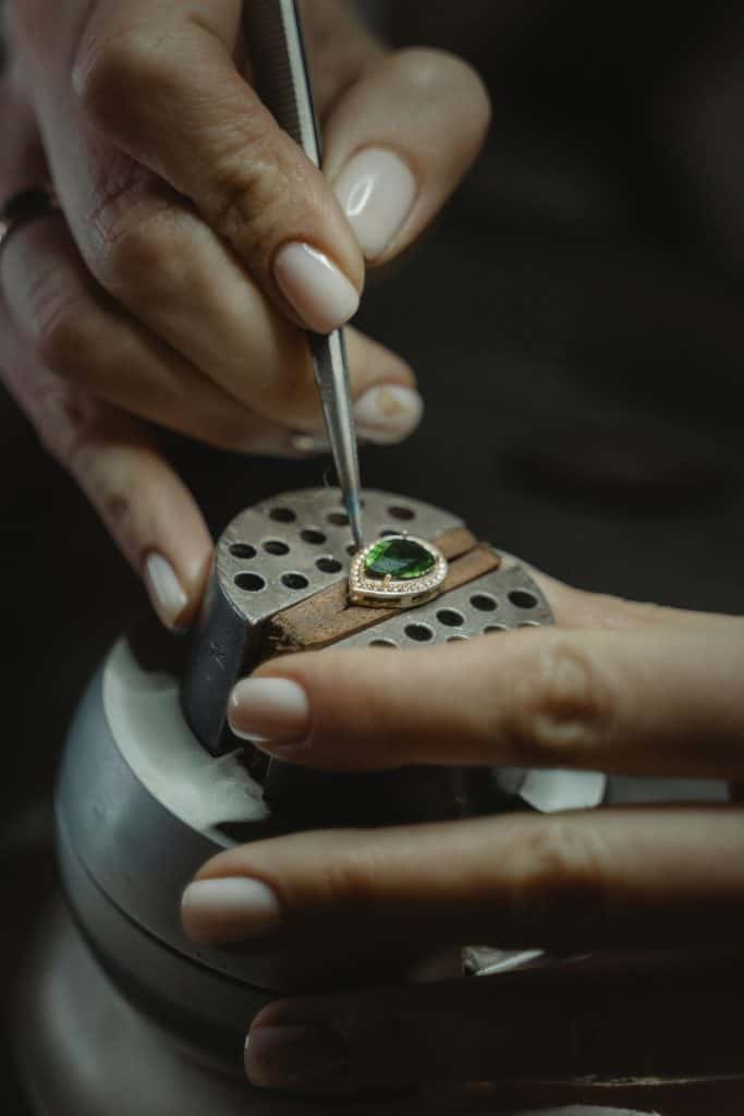 Jewellery making a ring with gemstone in workshop