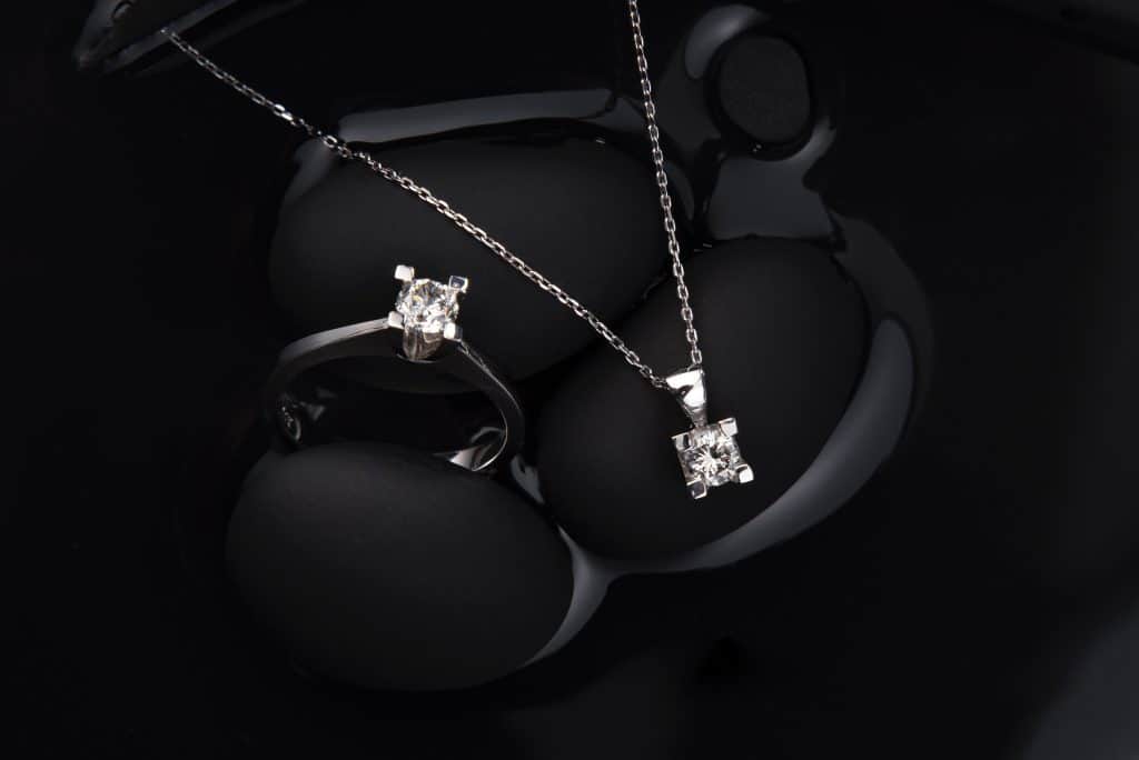 Diamond jewellery featured on black background.