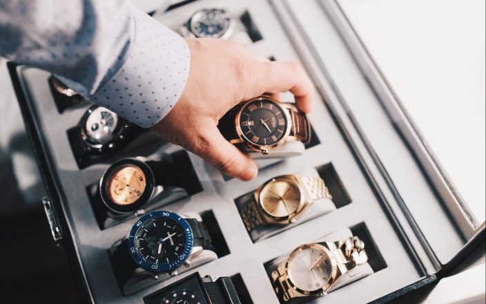 Luxury watches in a large watch display case.