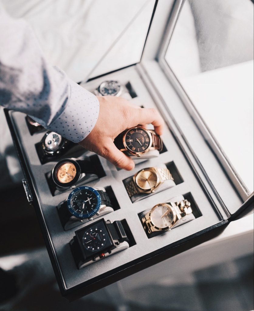 Luxury watches in a large watch display case.